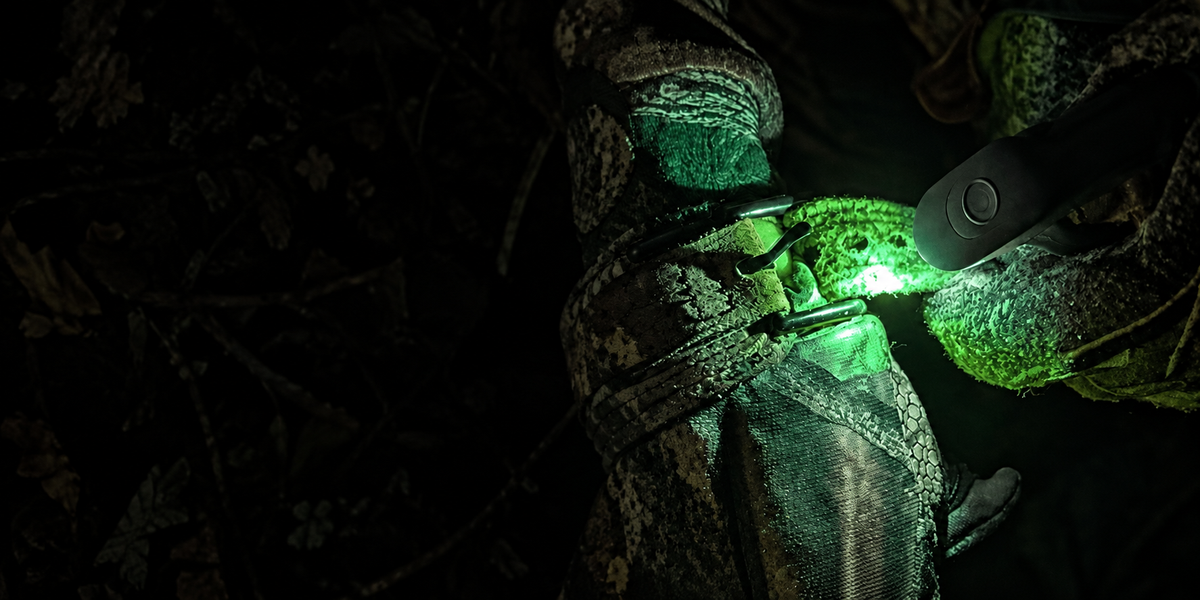 Green DEX FingerLight illuminating camouflage gloves and a strap buckle